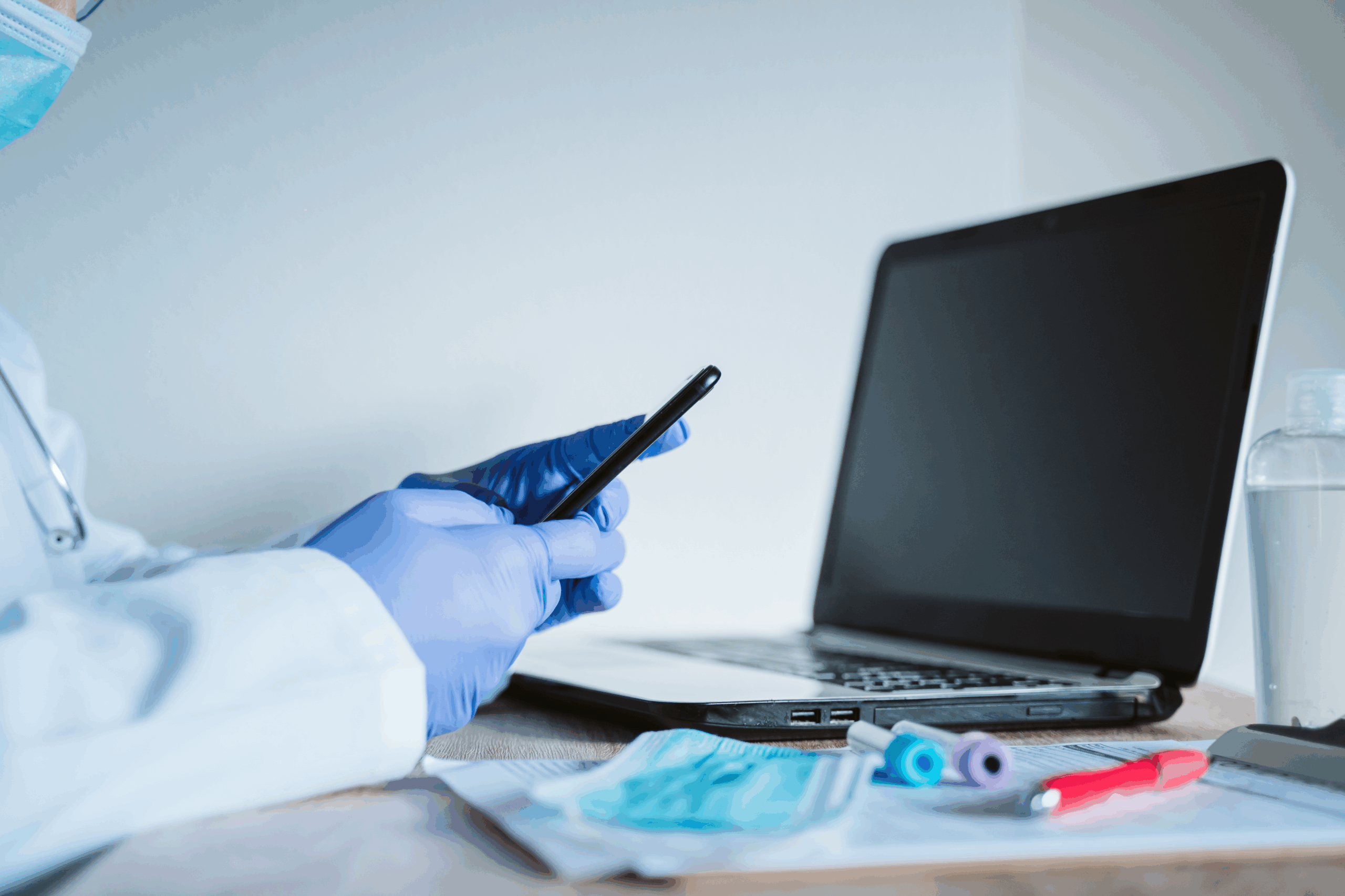doctor-man-working-on-laptop-and-mobile-phone-cor-2024-11-03-00-22-19-utc