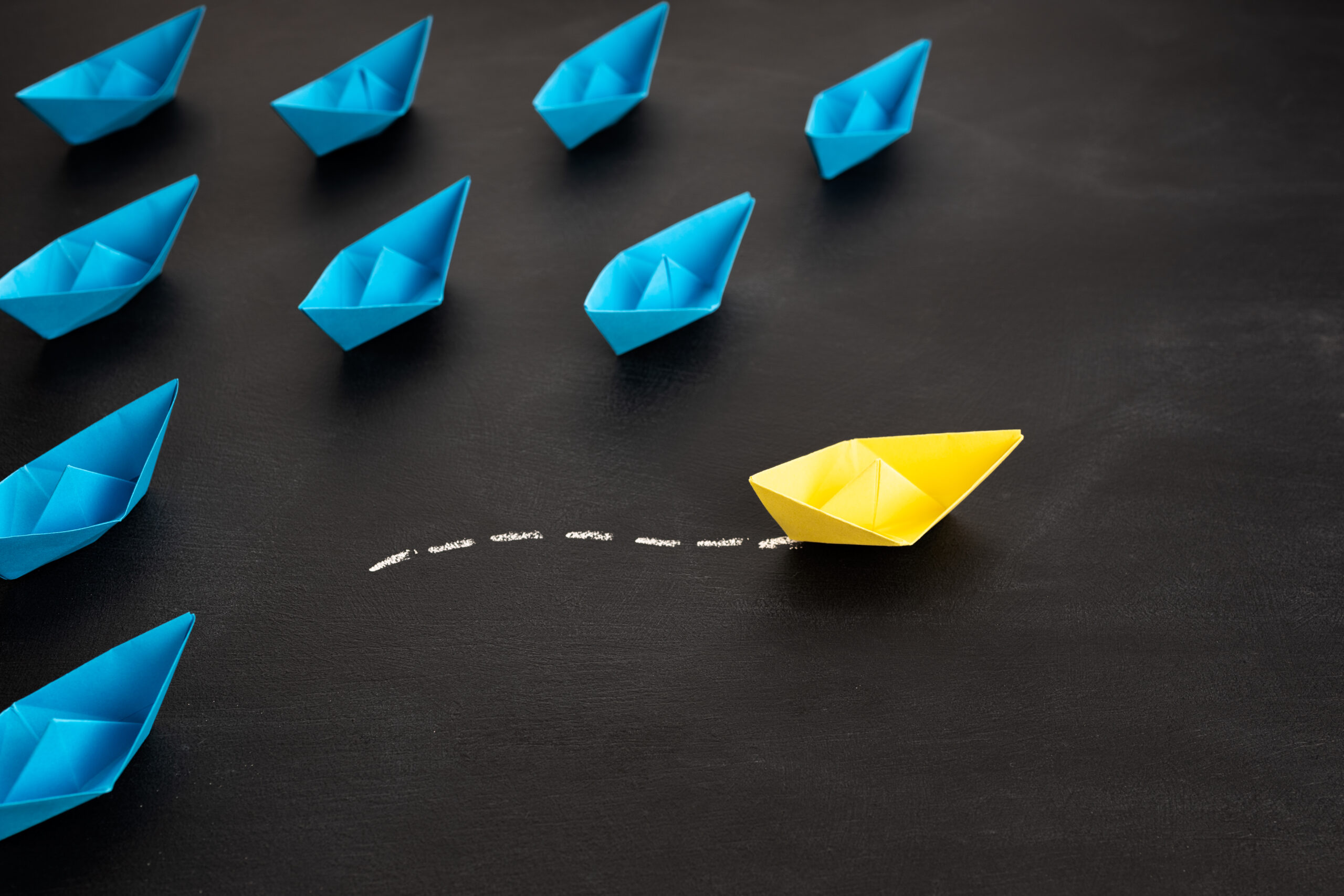 Leadership, unique or freedom concept. Yellow paper ship are different from others. Business for Innovative solution concepts